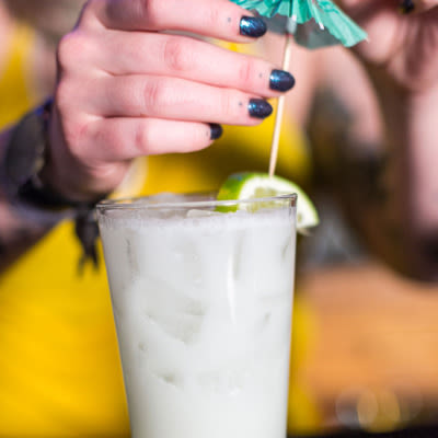 A bartender decorating a glass of cocktail