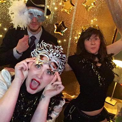 Three guest making funny faces and wearing costumes
