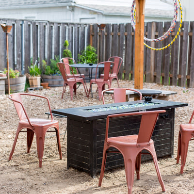 Picture of Mad Hanna back patio with herb garden, tables and chairs and gas firepit.