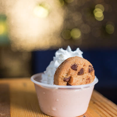 Mad Hanna chocolate chai pudding shot with whipped cream and a tiny chocolate chip cookie