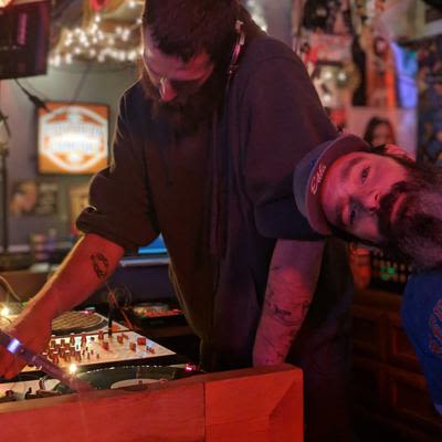 A DJ preforming in the DJ booth
