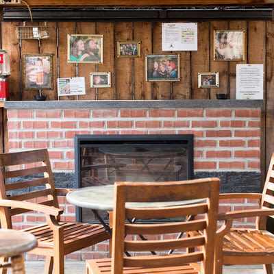 Mad Hanna patio with table and chairs and electric fireplace.