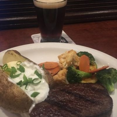Pub Steak with potatoes veggies and a glass of dark beer