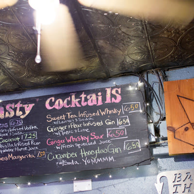 Chalkboard cocktail menu featuring infused drinks at Mad Hanna