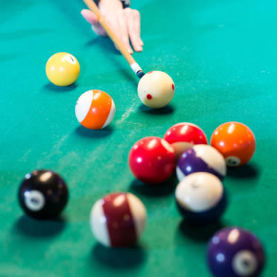 Close up of shooting pool on the pool table at Mad Hanna