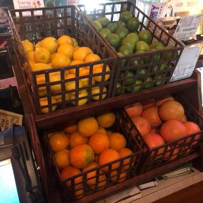 four baskets of fresh fruit, oranges, lemons, grapefruit, and limes,  used to make cocktails at Mad Hanna
