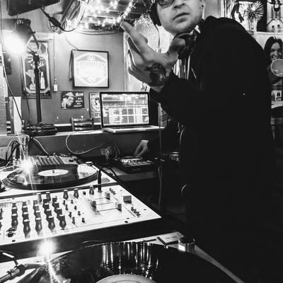 A DJ preforming in the DJ booth, known as the Cat Box, at Mad Hanna