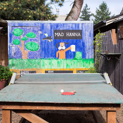 Mad Hanna patio with ping pong table and Duck Hunt inspired mural in background