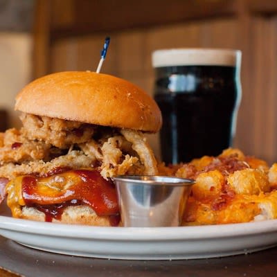 BBQ Bacon Cheeseburger with dip and a glass of dark beer