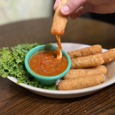 A hand dipping food