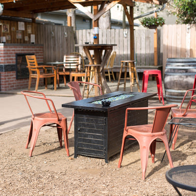 Picture of Mad Hanna back patio with tables and chairs and gas firepit.