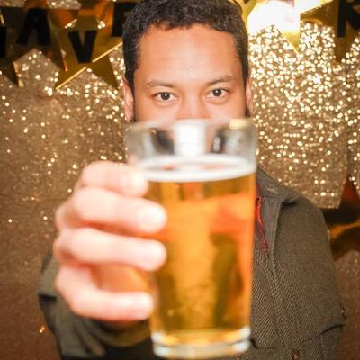 A guest holding a glass of beer