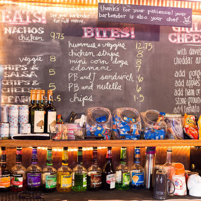 chalkboard food menu behind the bar at Mad Hanna