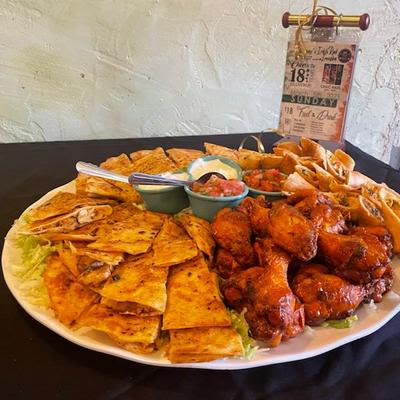 A large sampler plate with various foods