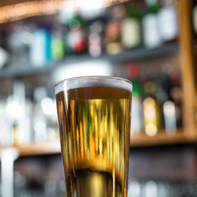 a properly poured pint of a golden lager
