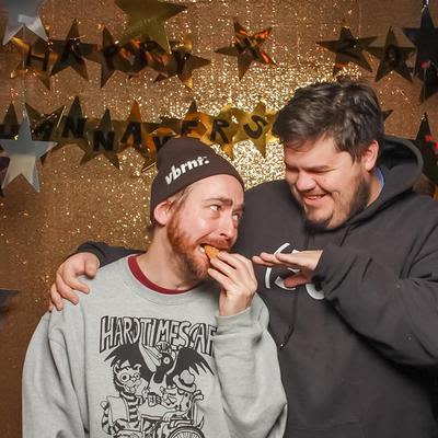 Two guests, hugging in front of the camera