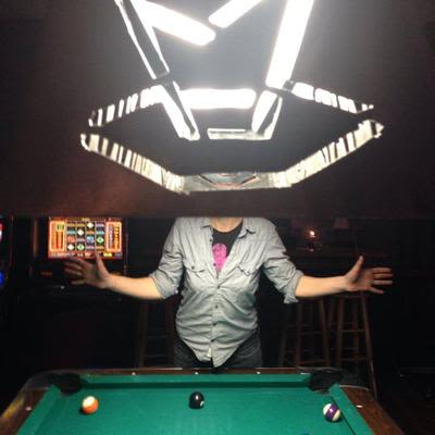 A guest behind the pool table