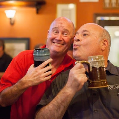 Customers smiling and drinking beer