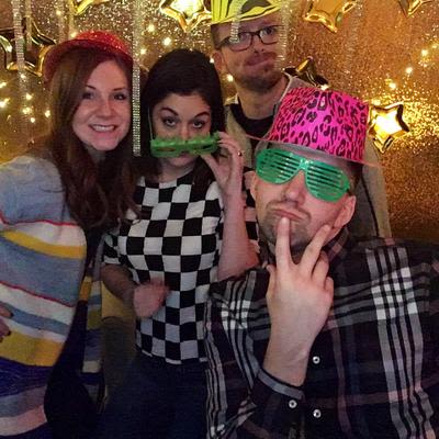 Four guests making funny faces and posing for a photo