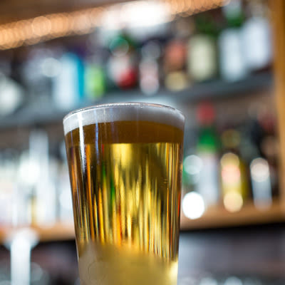 a properly poured pint of a golden lager
