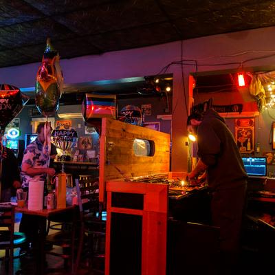 A DJ preforming in the DJ booth, known as the Cat Box, at Mad Hanna