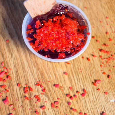 a cherry jello shot garnished with cherry pop rocks