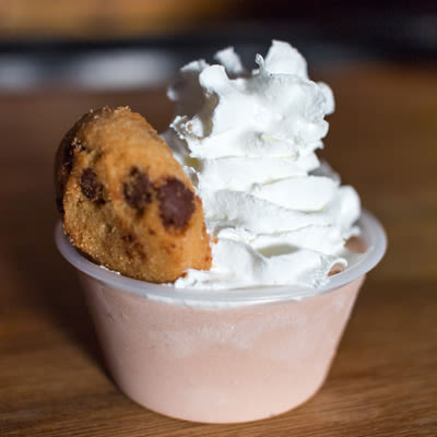 Mad Hanna chocolate pudding shot with whipped cream and a tiny chocolate chip cookie